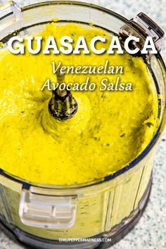 a food processor filled with yellow sauce on top of a counter next to the words guascaca