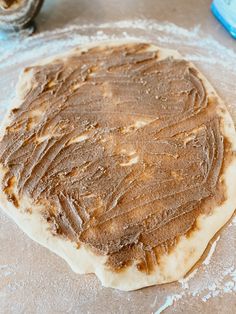 an uncooked pizza dough on a baking sheet