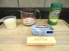 ingredients to make cake sitting on top of a cutting board next to a measuring cup