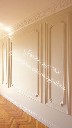 an empty room with wooden floors and white walls, decorated with decorative moldings that say happy new year