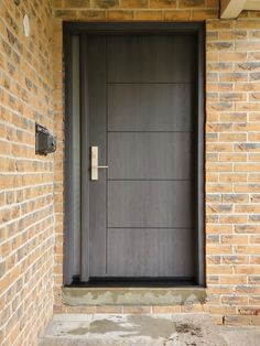 the front door is made of wood and has a metal handle on it's side