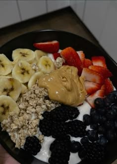 a bowl filled with yogurt, fruit and granola on top of it