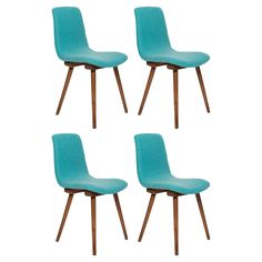 four blue chairs with wooden legs on a white background