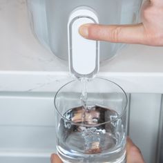 Keep filtered water on tap with this sleek dispenser. The white easy-slide lid holds two powerful filters. The membrane microfilter removes bacteria, parasites and microplastics, filtering 264 gallons of water for a full year of healthy, clean water. An activated carbon and ion exchange filter reduces chlorine, heavy metals, PFAS and unpleasant odors, ensuring two months of delicious drinking water. The filters remove undesirable elements without filtering out essential minerals such as magnesiu Ceramic Bakeware Set, Ceramic Bakeware, Life Straw, Essential Minerals, Water Dispensers, Cleaning Items, Filtered Water, Gallon Of Water, Bakeware Set