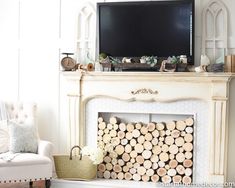 a living room with a fire place and television on top of the fireplace mantel