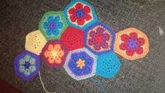 there are many crocheted flowers on the floor