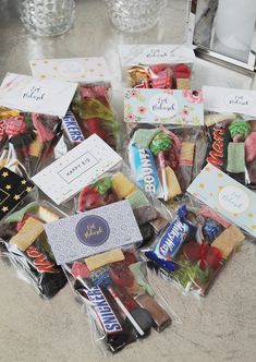 many different types of candy in bags on the counter