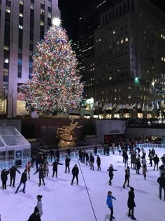 people skating on an ice rink with a christmas tree in the background at rockefeller square