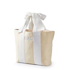 a white and beige tote bag with the word chic on it's side