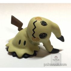 a toy figure is shown with a knife in it's mouth and on its back legs