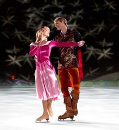 a man and woman skating on an ice rink at night with stars in the background