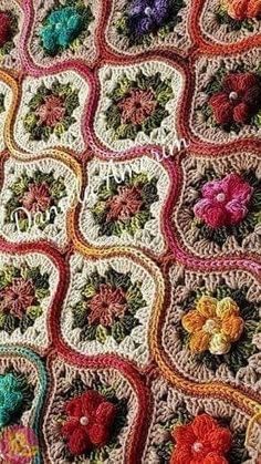 a crocheted blanket with flowers on it