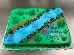 a birthday cake that is shaped like a river