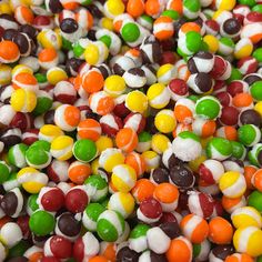 many different colored candies are in a pile