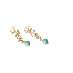 These enchanting gold-plated earrings feature a graceful cascade of three flowers, each one smaller than the last, creating a harmonious descent of delicate floral elegance. At the tip, a turquoise jade bead dusted with golden powder adds a soft, luminous touch, evoking the charm of nature kissed by sunlight. Gold plated earrings with turquoise jade beads.  The jewelry comes in an elegant box. Made in Belgium  Keep your jewelry away from harsh chemicals, such as household cleaners, chlorine, and beauty products. These can damage both the gemstones and the metal settings. Apply perfumes, lotions, and hairspray before putting on your jewelry. Use a soft, lint-free cloth to gently wipe your gemstones after each wear to remove any oils or residues. Store the jewelry in the box provided, to pre Blue Flower Earrings, Three Flowers, September Birthstone Jewelry, August Birthstone Jewelry, July Birthstone Jewelry, Gifts For New Mums, Pearl Jewellery Earrings, Jewelry Ring Box, Men's Jewelry Rings