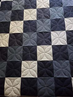 a black and white checkered quilt on a bed