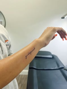 a woman's arm with a tattoo that reads, i love you in cursive writing