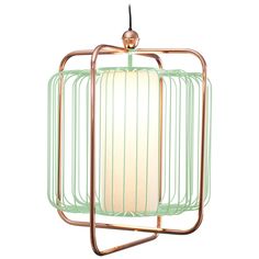 a light green lamp hanging from a metal frame with a white shade on the top