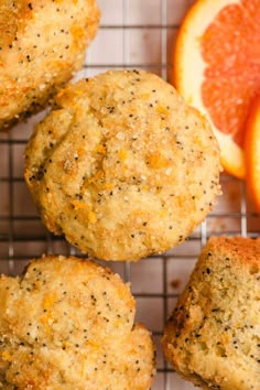 oranges and muffins on a cooling rack next to some sliced up grapefruit