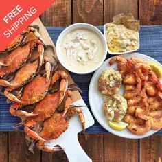 lobsters and shrimp are served on plates with dipping sauce