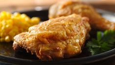 two pieces of fried food on a black plate