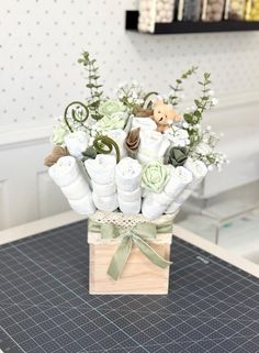 a vase filled with lots of baby items on top of a table