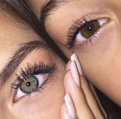 two people with their eyes close together