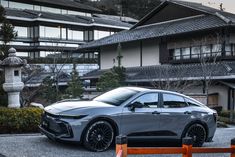 a silver car parked in front of a building