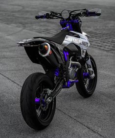 a white and black motorcycle parked on the street