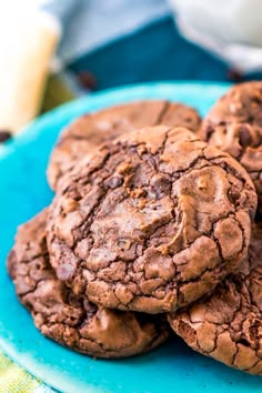 chocolate cookies are stacked on a blue plate