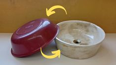 two bowls with lids sitting next to each other on top of a white countertop