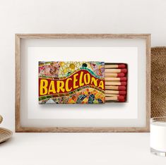 an art print of a matchbox with matches in it and the word barcelona written on it