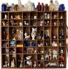 a wooden shelf filled with lots of figurines