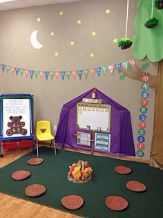 a classroom with lots of toys and decorations on the walls, including a tent for children to play in