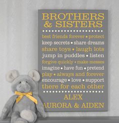 a gray teddy bear sitting in front of a yellow and grey sign that says brothers & sisters