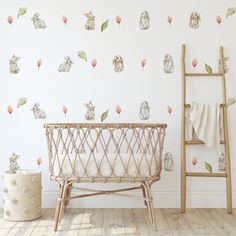 a baby crib in front of a wall with flowers and rabbits on it