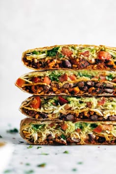 three tacos stacked on top of each other