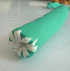 a green toothbrush sitting on top of a white counter