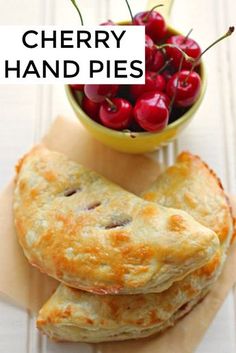 cherry hand pies are stacked on top of each other with cherries in a bowl