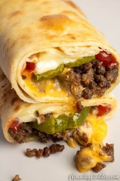 a close up of a burrito on a plate