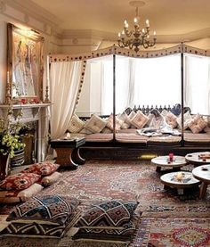 an image of a living room with couches and rugs on the floor in front of a large mirror