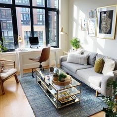 a living room filled with furniture and lots of windows next to a window sill