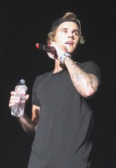 a man holding a water bottle in his right hand