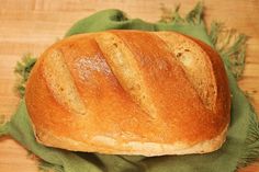 a loaf of bread sitting on top of a green cloth