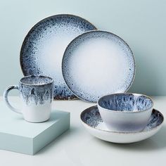 a white and blue dinner set on a table