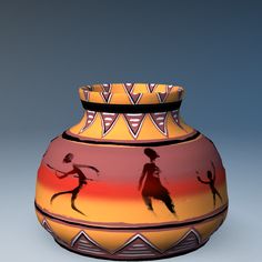 a colorful vase with two people on it