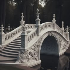 an ornate white bridge over a body of water