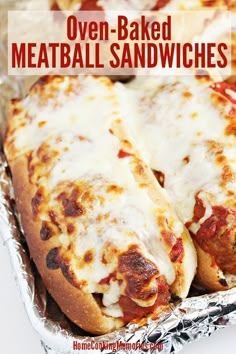 two cheesy oven baked meatball sandwiches in tin foil with text overlay