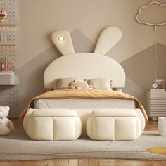 a white bed sitting on top of a wooden floor next to a teddy bear toy