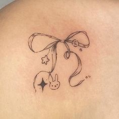 the back of a woman's shoulder with an outline of a bunny and stars on it